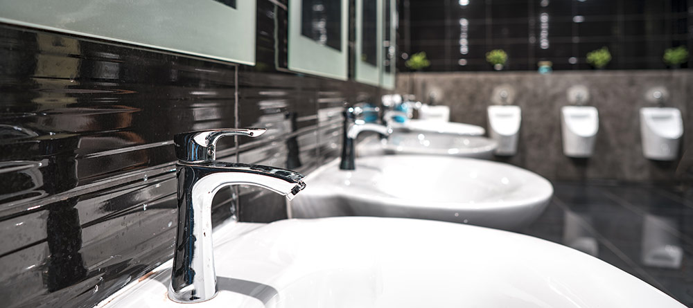 A photo of a very smart office washroom in natural brown tones