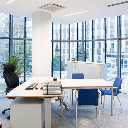 Photo of desk with meeting chairs in modern office