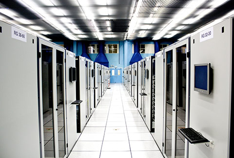 photo looking down between a row of computer servers in special room