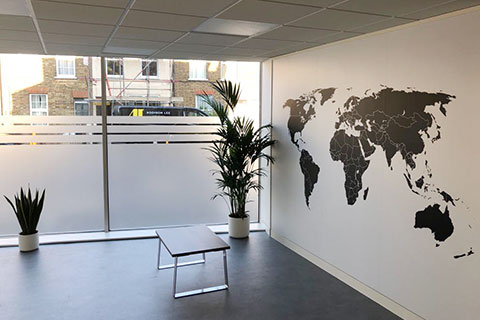 Photo of small office with vertical hanging blinds